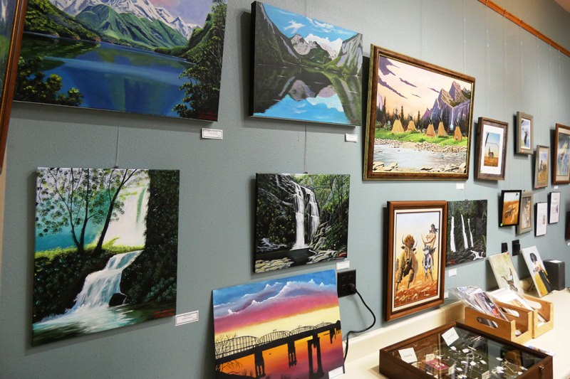 A wall of paintings by Mike Sherman
